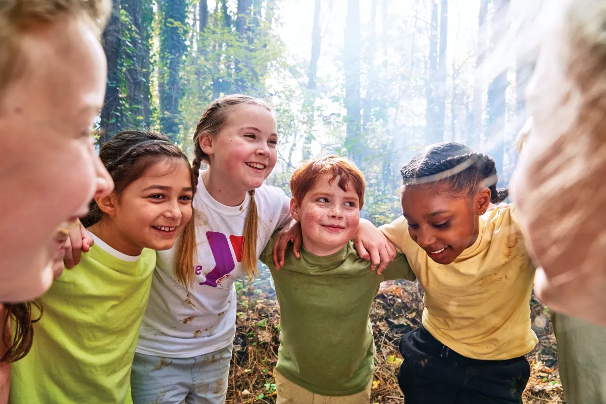 Happy Kids in huddle at summer camp